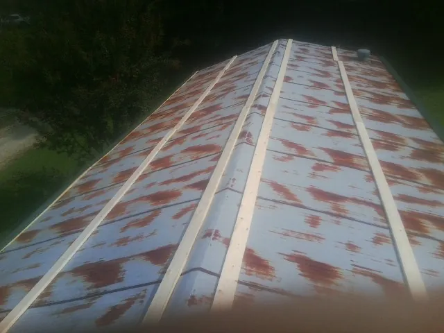 Rusted metal roof panels with new wood purlins before replacement — Storm Damage Roof Repair in Saugerties by Roofing Brothers