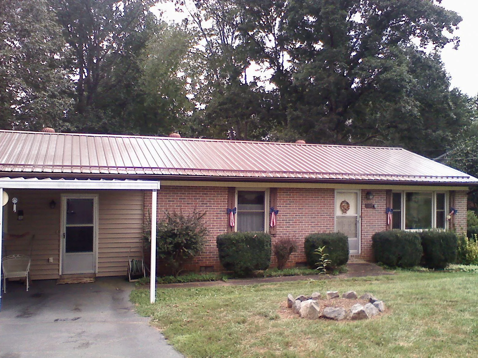 Bronze metal roof and carport on a brick ranch home — Roof Repair work by our crew in Saugerties